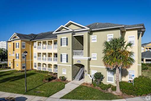 A building with a palm tree in front of it.