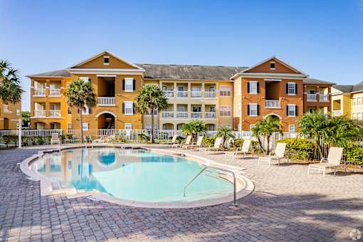 A large building with a pool in front.