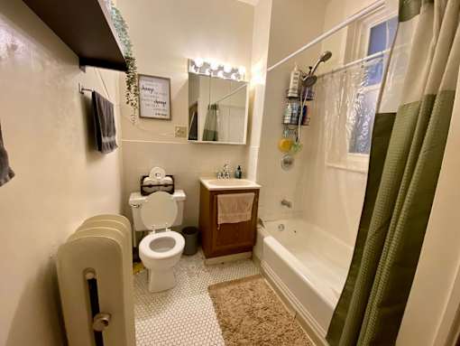 A bathroom with a toilet, sink, and bathtub.