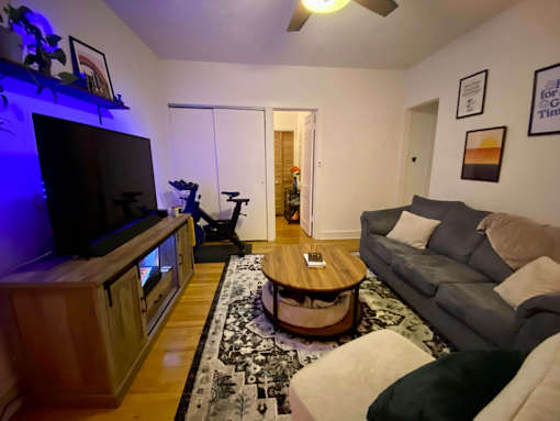 A living room with a grey couch and a wooden coffee table.