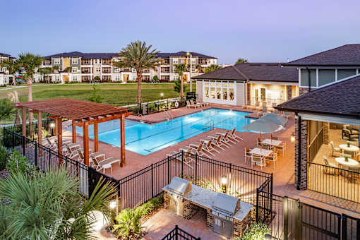 A poolside area with a hot tub and loungers.