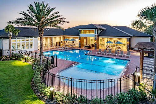 A large house with a pool in the backyard.