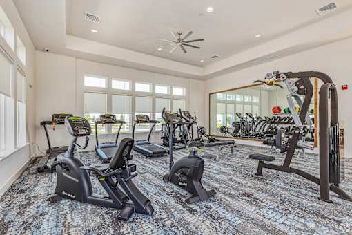 A spacious gym with a variety of exercise equipment.