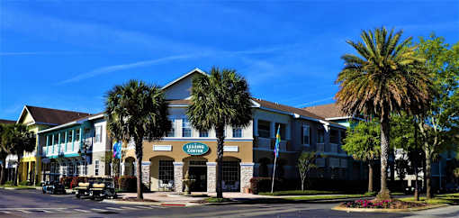 A building with a sign that says "Living Center" is surrounded by palm trees.