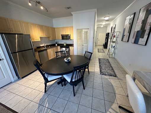A kitchen with a table and chairs.