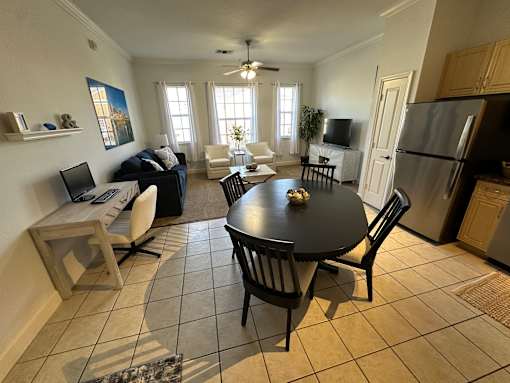 A kitchen with a table and chairs in the middle of the room.