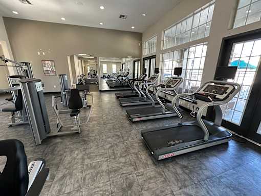 A gym with treadmills and elliptical machines.