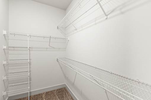 Empty white shelves in a room.
