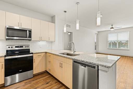 A kitchen with wooden cabinets and stainless steel appliances.
