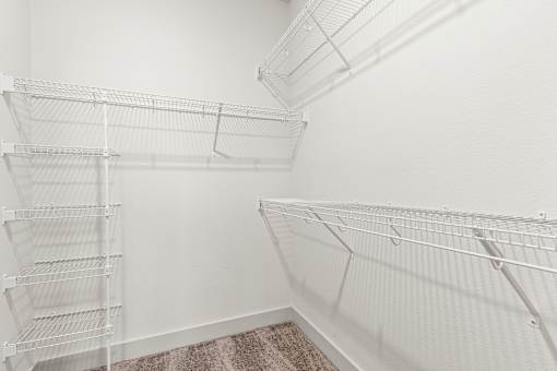 Empty white shelves in a room.