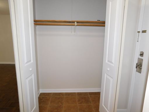 A white door with a brown shelf above it.