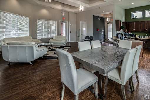 A modern dining room with a large table and chairs.