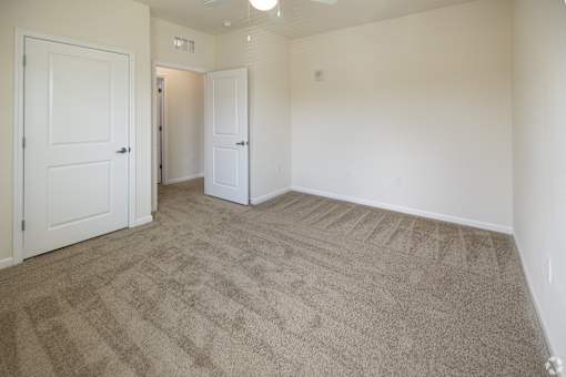 A room with carpeted floor and white walls.