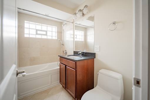A bathroom with a toilet, sink, and bathtub.