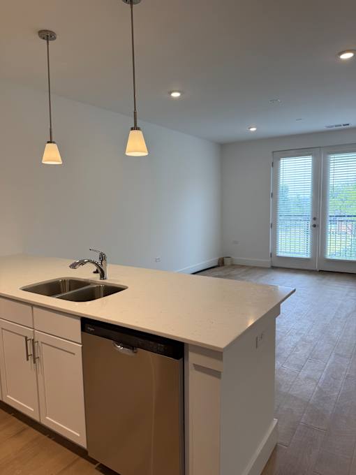 A kitchen with a sink and cabinets.