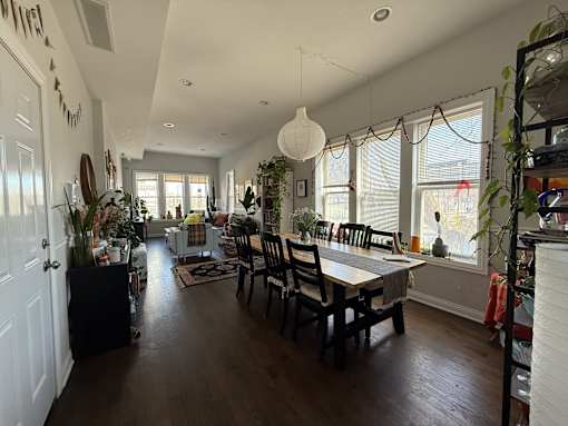 A dining room with a table and chairs.
