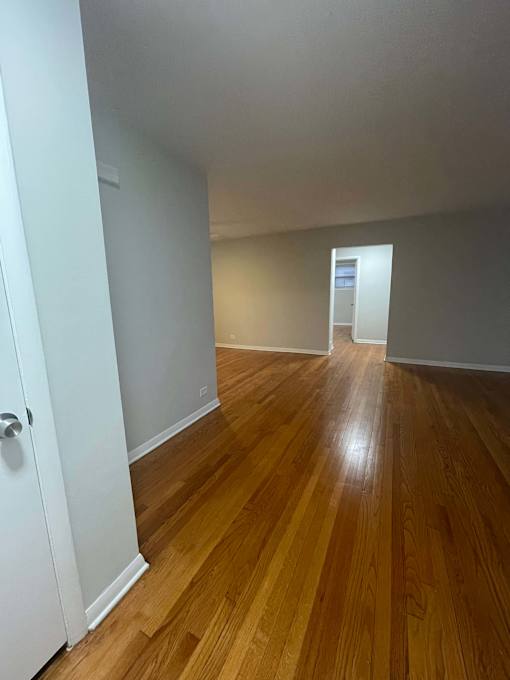 A room with wooden floors and white walls.