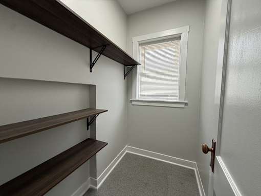 A room with a window and a door.