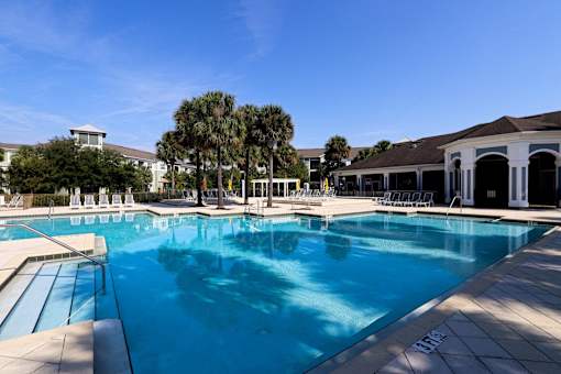 A large swimming pool with a blue tinted water.