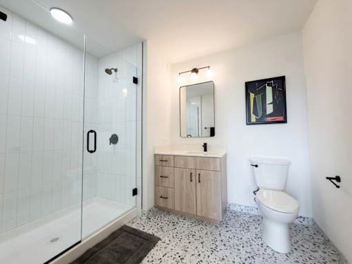 A white toilet sits next to a sink in a bathroom.