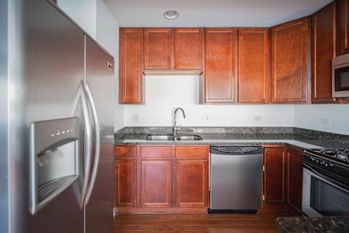 A modern kitchen with wooden cabinets and stainless steel appliances.