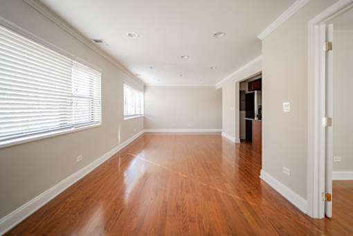A room with wooden floors and white walls.
