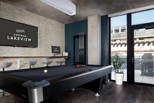 A pool table in a room with a sign that says "Centrum Lakeview".