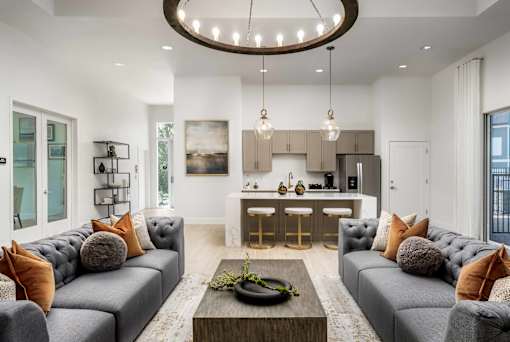 A modern living room with grey sofas and a wooden coffee table.