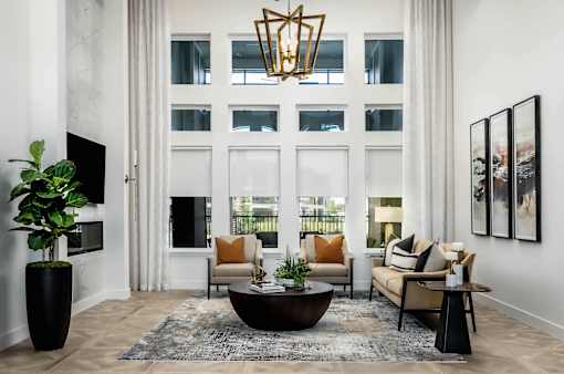 A living room with a large window, a sofa, a coffee table, and a TV.