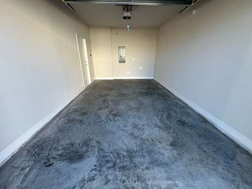 A room with a grey floor and white walls.