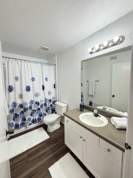 A bathroom with a white toilet and a white sink.