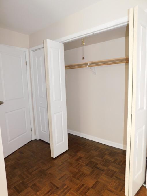 A room with a wooden floor and a white door.
