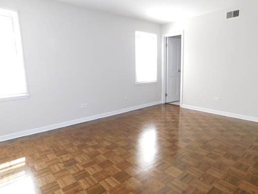 A room with a wooden floor and a door.