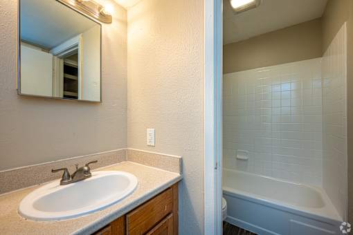 A bathroom with a sink and a bathtub.
