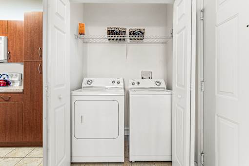 A small laundry room with a washer and dryer.