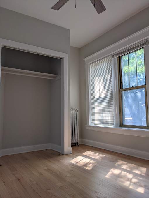 A room with a window and a radiator on the wall.