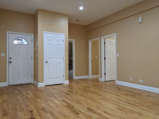 A room with wooden floors and white doors.
