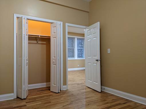 A room with a white door and a window.