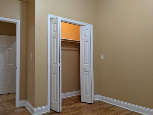 A room with a white door and a brown wall.