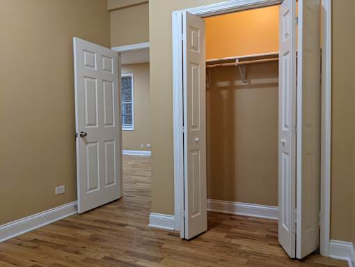 A room with a white door and a brown wall.