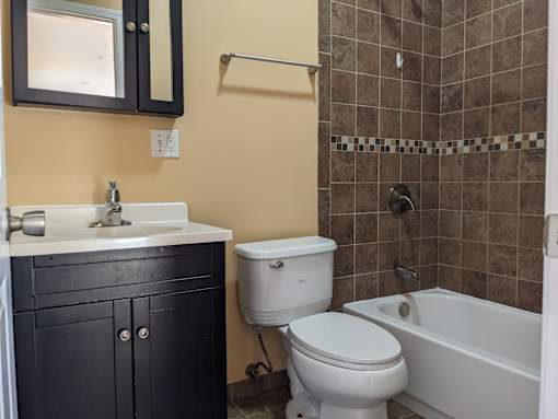 A bathroom with a white toilet and sink.