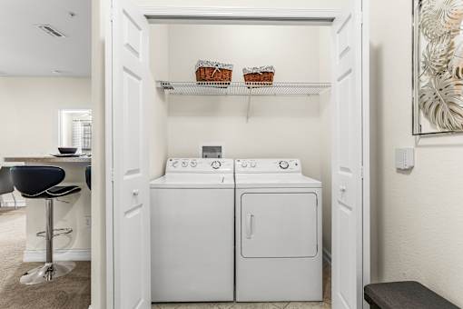 A small laundry room with a washer and dryer.