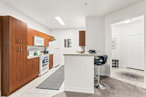 A kitchen with white appliances and wooden cabinets.