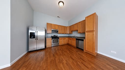 A kitchen with wooden cabinets and stainless steel appliances.
