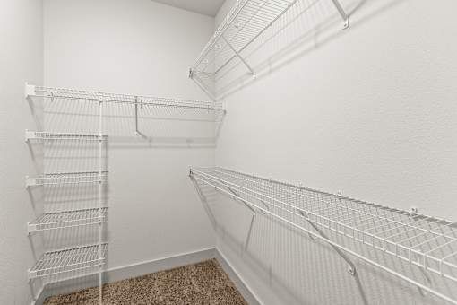 Empty white shelves in a room.