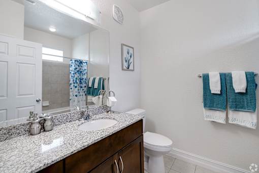 A bathroom with a white toilet and a sink.