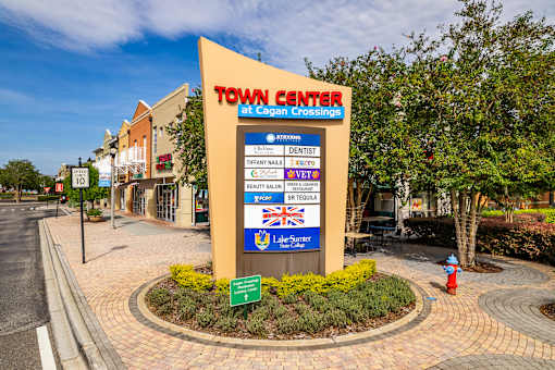A sign for the Town Center at Cagan Crossing stands in front of a building.