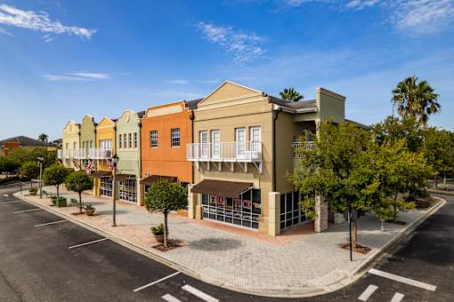 A street view of a row of colorful buildings with a clear blue sky above.