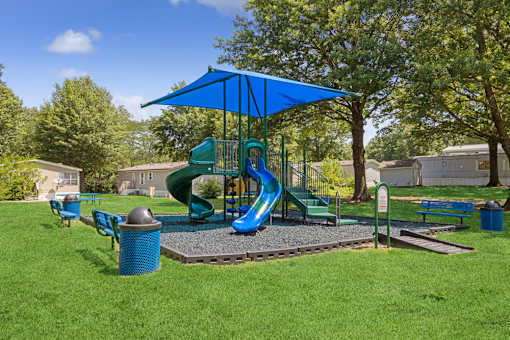 Playground with sun cover at Southfork MHC in Belton, MO