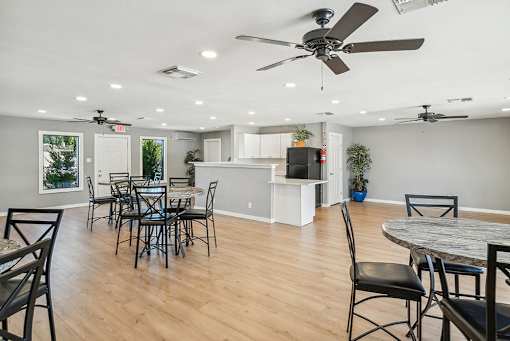 A dining room with a table set for six.